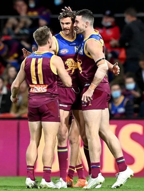 Joe Daniher of the Lions is congratulated by team mates after kicking a goal during the round 17 AFL match between Brisbane Lions and St Kilda Saints...