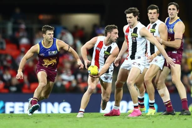 Luke Dunstan of the Saints handballs during the round 17 AFL match between Brisbane Lions and St Kilda Saints at The Gabba on July 10, 2021 in...