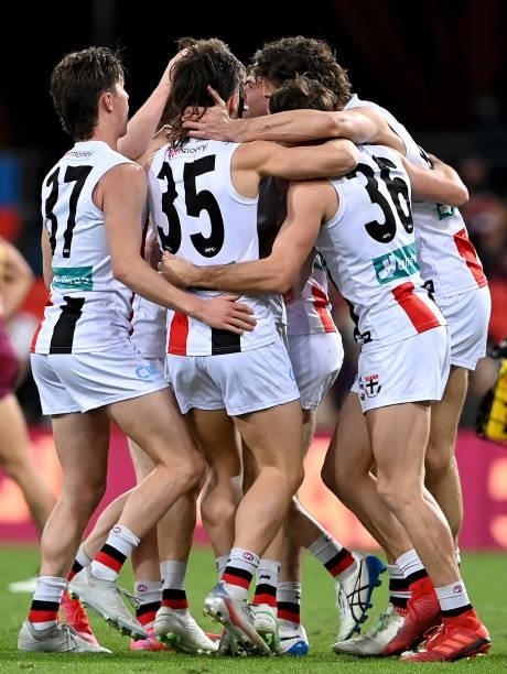 Daniel McKenzie of the Saints is congratulated by team mates after kicking a goal during the round 17 AFL match between Brisbane Lions and St Kilda...