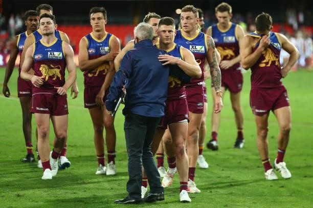 Dayne Zorko of the Lions leave the field with Coach Chris Fagan after his 200th AFL match during the round 17 AFL match between Brisbane Lions and St...