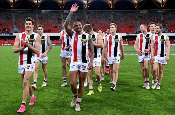 Bradley Hill of the Saints and team mates celebrate victory after the round 17 AFL match between Brisbane Lions and St Kilda Saints at The Gabba on...