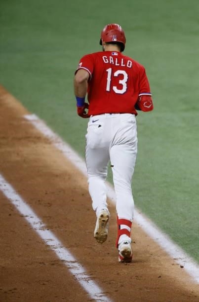Joey Gallo of the Texas Rangers goes to first after walking against the Oakland Athletics during the sixth inning at Globe Life Field on July 9, 2021...