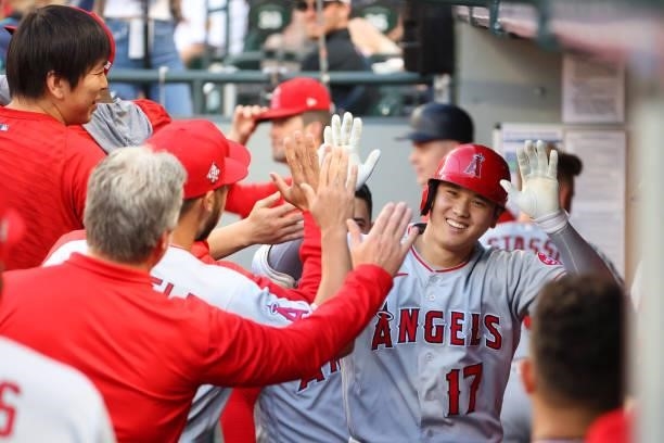 Shohei Ohtani of the Los Angeles Angels celebrates in the dugout after hitting a solo home run during the third inning against the Seattle Mariners...