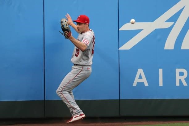Phil Gosselin of the Los Angeles Angels is unable to make the catch off a two-run double by Shed Long Jr. #4 of the Seattle Mariners during the...