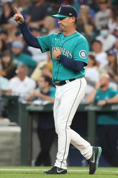 Manager Scott Servais of the Seattle Mariners signals while making a pitching change during the sixth inning against the Los Angeles Angels at...