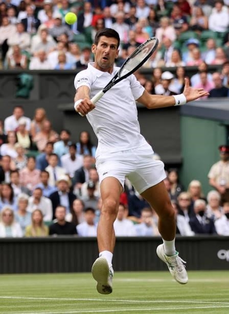 Novak Djokovic of Serbia plays a backhand volley in his Men's Singles Semi-Final match against Denis Shapovalov of Canada during Day Eleven of The...