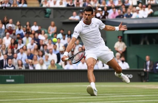 Novak Djokovic of Serbia plays a backhand volley in his Men's Singles Semi-Final match against Denis Shapovalov of Canada during Day Eleven of The...