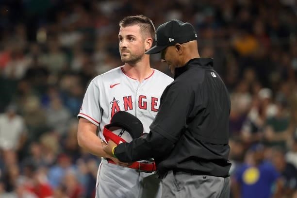 Mike Mayers of the Los Angeles Angels is checked by umpire CB Bucknor for illegal substances after being removed from the game during the eighth...
