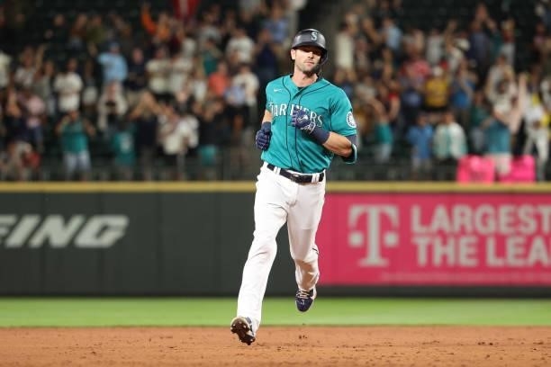 Mitch Haniger of the Seattle Mariners laps the bases after hitting a grand slam to take a 7-3 lead against the Los Angeles Angels during the eighth...