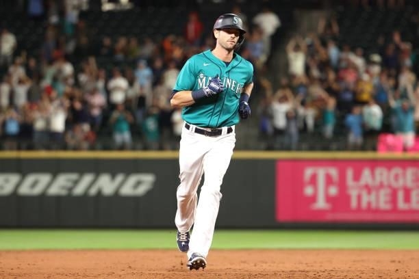 Mitch Haniger of the Seattle Mariners laps the bases after hitting a grand slam to take a 7-3 lead against the Los Angeles Angels during the eighth...