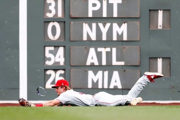 Luke Williams of the Philadelphia Phillies dives to catch a fly ball hit by Alex Verdugo of the Boston Red Sox during the first inning at Fenway Park...