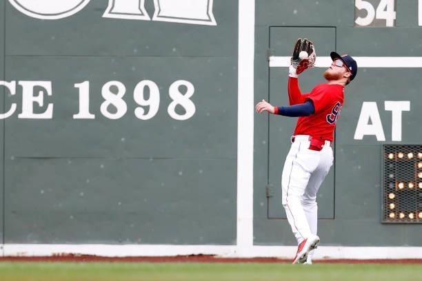 Alex Verdugo of the Boston Red Sox catches a fly ball hit by Andrew McCutchen of the Philadelphia Phillies during the first inning at Fenway Park on...