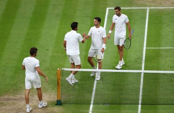 Nikola Mektic of Croatia and Mate Pavic of Croatia interact with Marcel Granollers of Spain and Horacio Zeballos of Argentina after winning their...