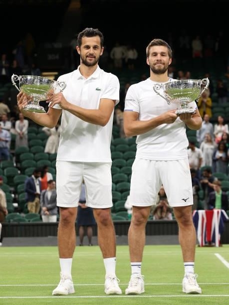Nikola Mektic of Croatia and Mate Pavic of Croatia celebrate with their trophies after winning their Men's Doubles Final match against Marcel...