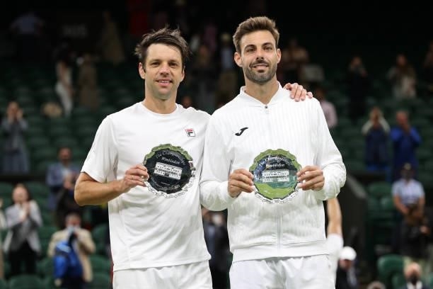 Marcel Granollers of Spain and Horacio Zeballos of Argentina pose with their runners-up trophies after losing their Men's Doubles Final match against...