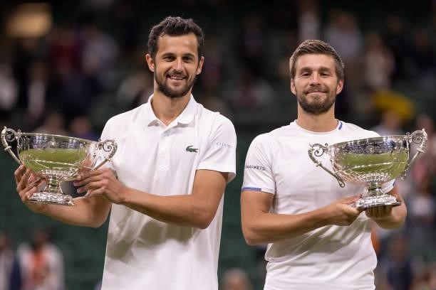 Mate Pavic of Croatia and Nikola Mektic of Croatia celebrate with their trophies after winning their Men's Doubles Final match against Marcel...
