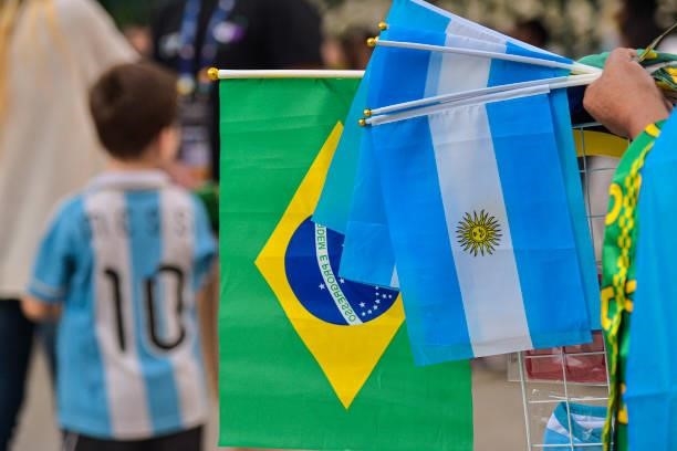 Street vendor holds flags of Argentina and Brazil outside the stadium prior to the final of Copa America Brazil 2021 between Brazil and Argentina at...