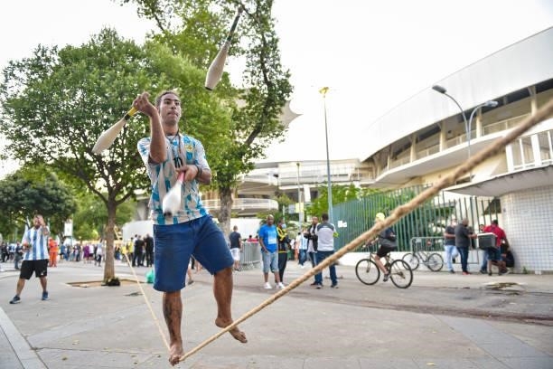 Man wearing the Argentine jersey juggles outside the stadium prior to the final of Copa America Brazil 2021 between Brazil and Argentina at Maracana...