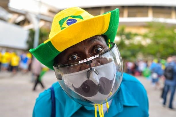 Fan of Brazil poses wearing a plastic mask outside the stadium prior to the final of Copa America Brazil 2021 between Brazil and Argentina at...