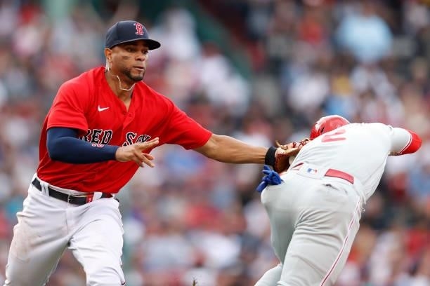 Xander Bogaerts of the Boston Red Sox picks off Jean Segura of the Philadelphia Phillies during the seventh inning at Fenway Park on July 10, 2021 in...