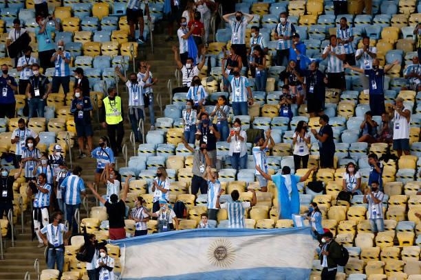Fans of Argentina chant with flags as they wait for the start of the match in the stands prior to the final of Copa America Brazil 2021 between...