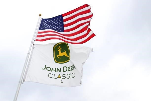 The American flag and the John Deere flag are seen during the third round of the John Deere Classic at TPC Deere Run on July 10, 2021 in Silvis,...