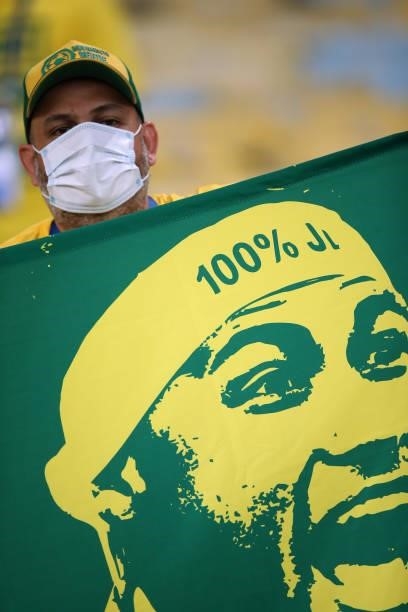 Fan of Brazil holds a flag of Neymar Jr. In the stands prior to the final of Copa America Brazil 2021 between Brazil and Argentina at Maracana...