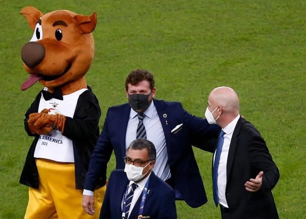 President of FIFA Gianni Infantino and President of CONMEBOL Alejandro Dominguez talk as the tournament mascot 'Pibe' poses prior to the final of...