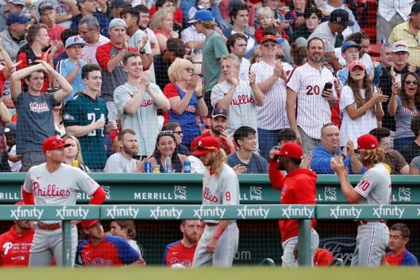 Philadelphia Phillies fans celebrate behind the dugout during the eighth inning against the Boston Red Sox at Fenway Park on July 10, 2021 in Boston,...