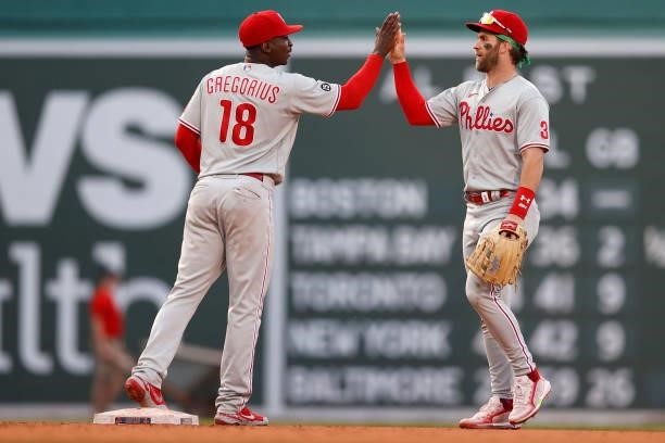 Bryce Harper of the Philadelphia Phillies and Didi Gregorius celebrate after defeating the Boston Red Sox 11-2 at Fenway Park on July 10, 2021 in...
