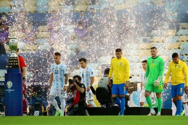 Lautaro Martinez of Argentina, Marcos Acuña of Argentina, Thiago Silva of Brazil and Ederson of Brazil enter the pitch prior to the final of Copa...