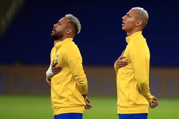 Neymar Jr. And Richarlison of Brazil sing the national anthem prior to the final of Copa America Brazil 2021 between Brazil and Argentina at Maracana...
