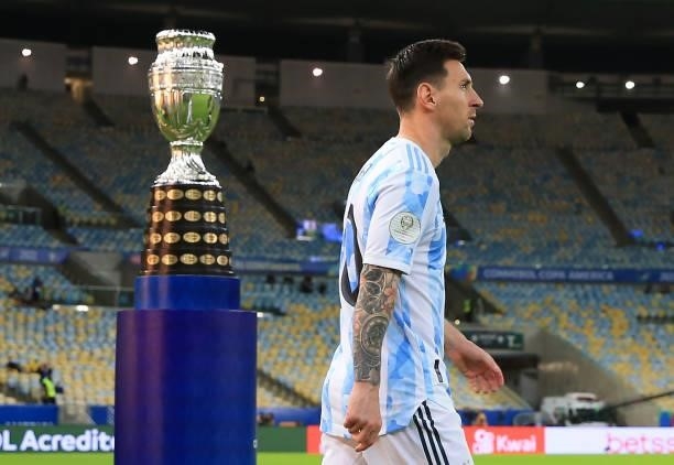 Lionel Messi of Argentina enters the pitch as he passes next to the trophy prior to the final of Copa America Brazil 2021 between Brazil and...