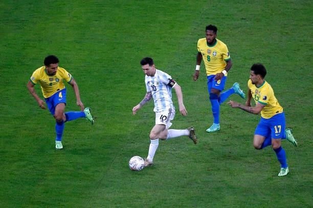 Lionel Messi of Argentina controls the ball against Marquinhos , Fred and Lucas Paqueta of Brazil during the final of Copa America Brazil 2021...