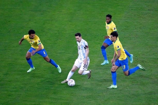 Lionel Messi of Argentina controls the ball against Marquinhos , Fred and Lucas Paqueta of Brazil during the final of Copa America Brazil 2021...