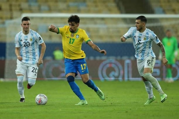 Lucas Paqueta of Brazil fights for the ball with Giovani Lo Celso and Leandro Paredes of Argentina during the final of Copa America Brazil 2021...