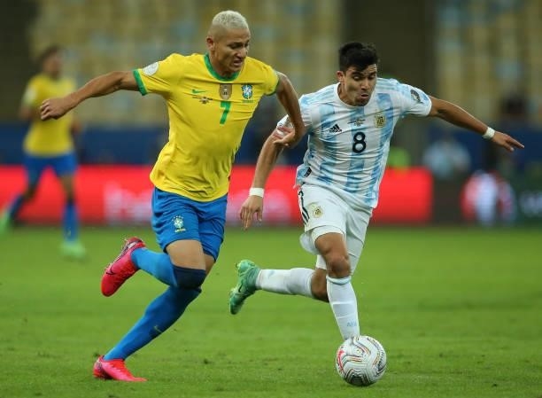 Richarlison of Brazil fights for the ball with Marcos Acuña of Argentina during the final of Copa America Brazil 2021 between Brazil and Argentina at...