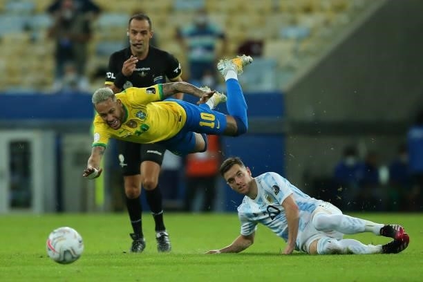 Neymar Jr. Of Brazil falls down against Giovani Lo Celso of Argentina during the final of Copa America Brazil 2021 between Brazil and Argentina at...