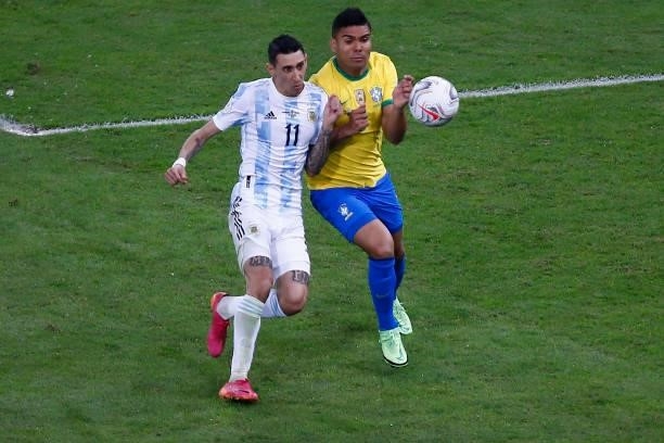 Angel Di Maria of Argentina fights for the ball with Casemiro of Brazil during the final of Copa America Brazil 2021 between Brazil and Argentina at...