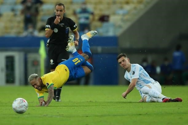 Neymar Jr. Of Brazil falls down against Giovani Lo Celso of Argentina during the final of Copa America Brazil 2021 between Brazil and Argentina at...