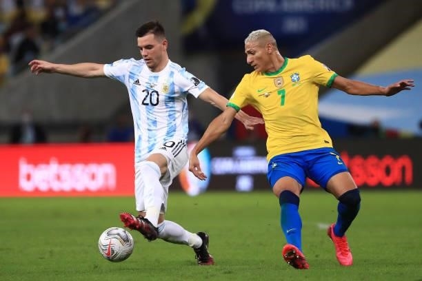 Giovani Lo Celso of Argentina fights for the ball with Richarlison of Brazil during the final of Copa America Brazil 2021 between Brazil and...