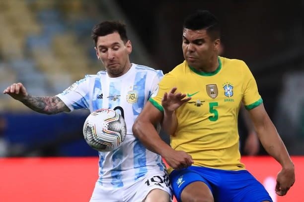 Lionel Messi of Argentina fights for the ball with Casemiro of Brazil during the final of Copa America Brazil 2021 between Brazil and Argentina at...