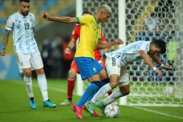 Marcos Acuña of Argentina fights for the ball with Richarlison of Brazil during the final of Copa America Brazil 2021 between Brazil and Argentina at...