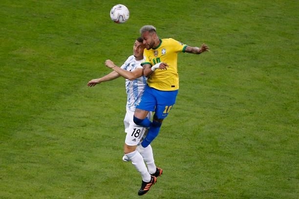Neymar Jr. Of Brazil heads the ball against Guido Rodriguez of Argentina during the final of Copa America Brazil 2021 between Brazil and Argentina at...