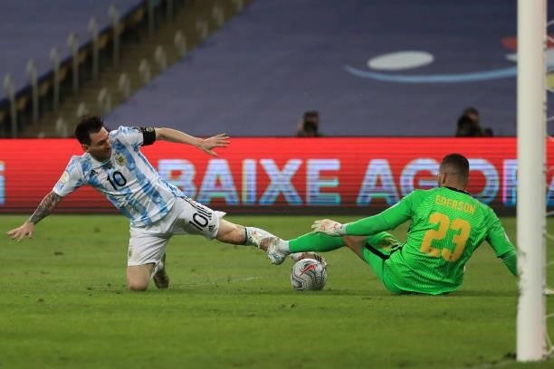Lionel Messi of Argentina fights for the ball with Ederson of Brazil during the final of Copa America Brazil 2021 between Brazil and Argentina at...