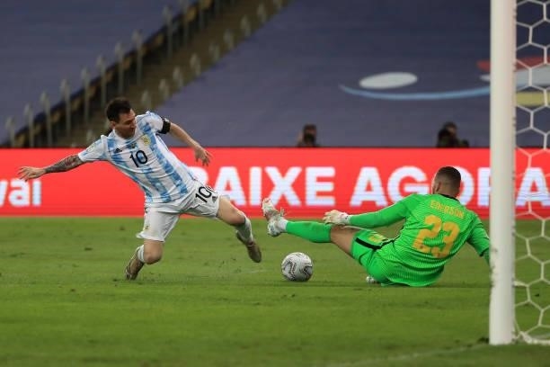 Lionel Messi of Argentina fights for the ball with Ederson of Brazil during the final of Copa America Brazil 2021 between Brazil and Argentina at...