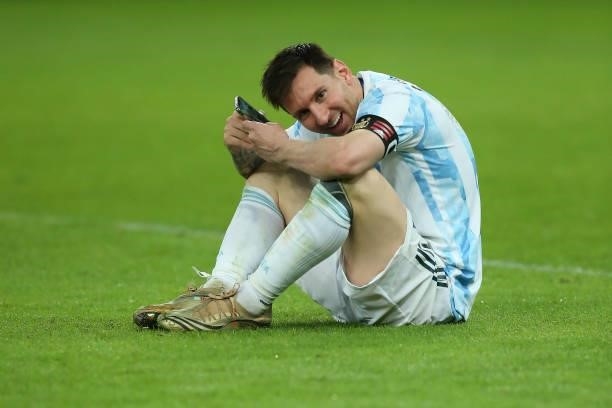 Lionel Messi of Argentina celebrates as he talks on his phone with his family after winning the final of Copa America Brazil 2021 between Brazil and...
