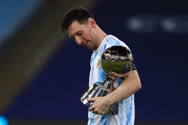Lionel Messi of Argentina holds his top scorer award after winning the final of Copa America Brazil 2021 between Brazil and Argentina at Maracana...