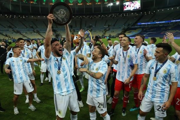 Cristian Romero of Argentina lifts the trophy as he celebrates with teammates after winning the final of Copa America Brazil 2021 between Brazil and...