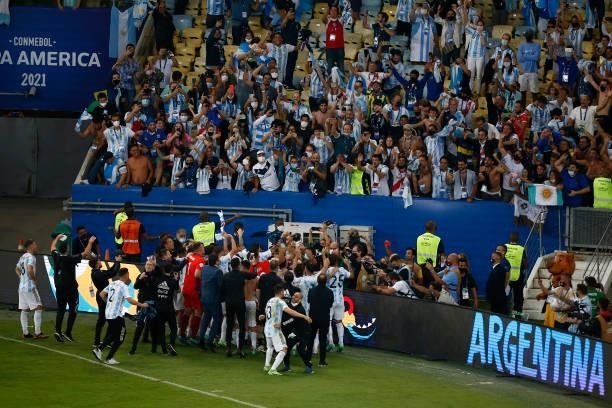 Players of Argentina celebrate with fans after winning the final of Copa America Brazil 2021 between Brazil and Argentina at Maracana Stadium on July...